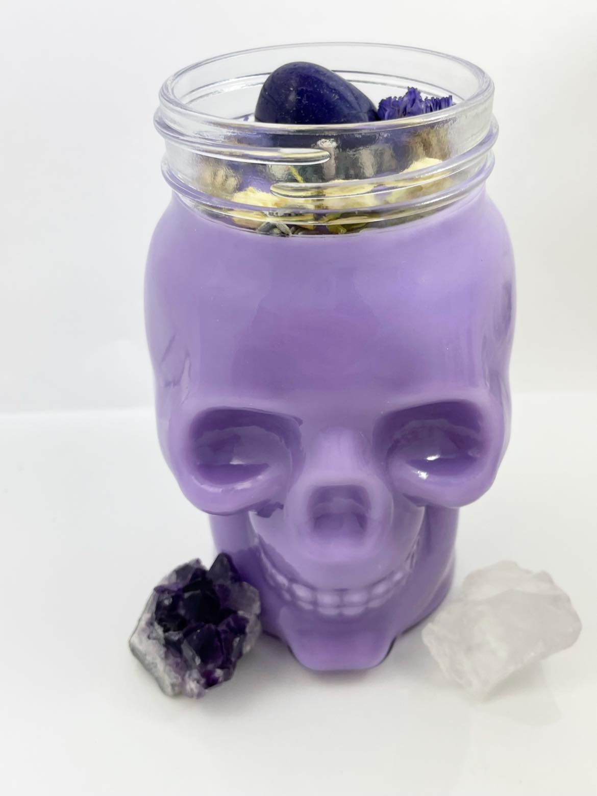 Purple glass skull candle with crystals